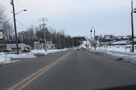 A view of a street on a winter's day in Hortonville, Wisconsin. The street is clear but snow lines both sides. Hortonville, Wisconsin is a location served by Rosenow Customs.