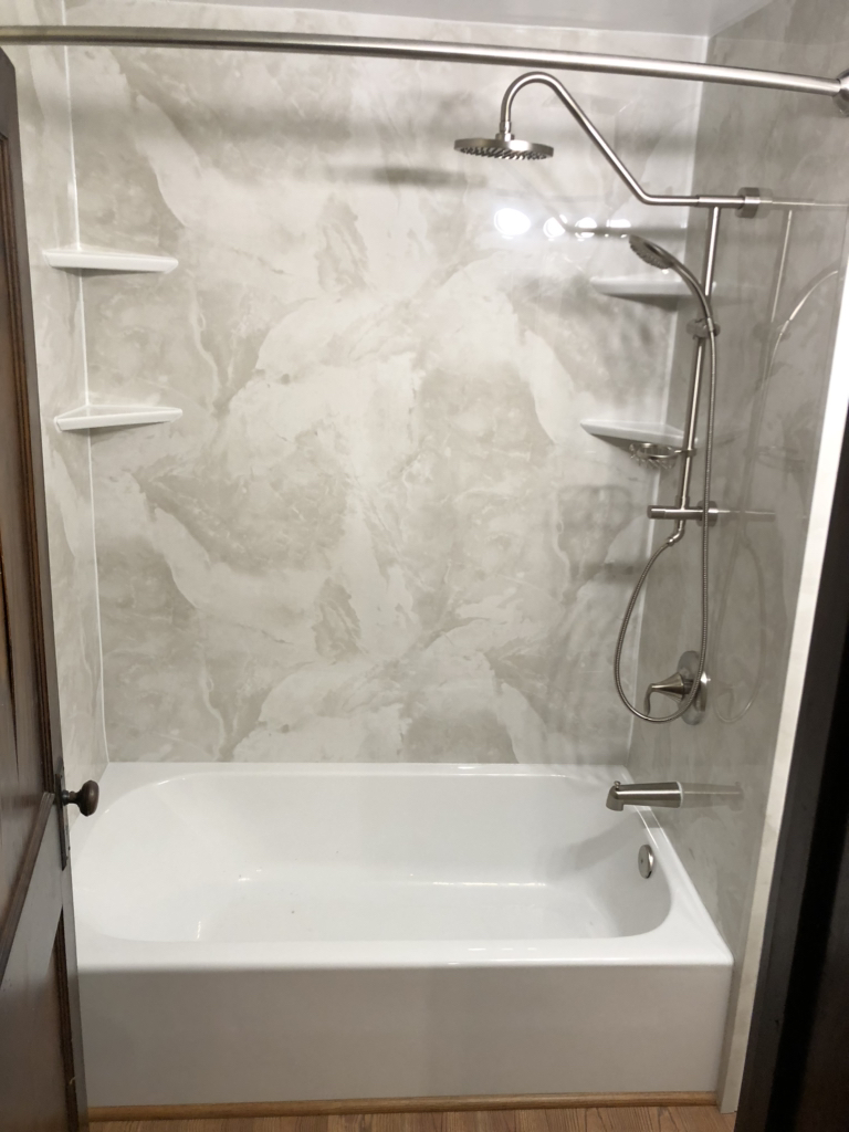 A newly installed bath with marble accented background in a bathroom
